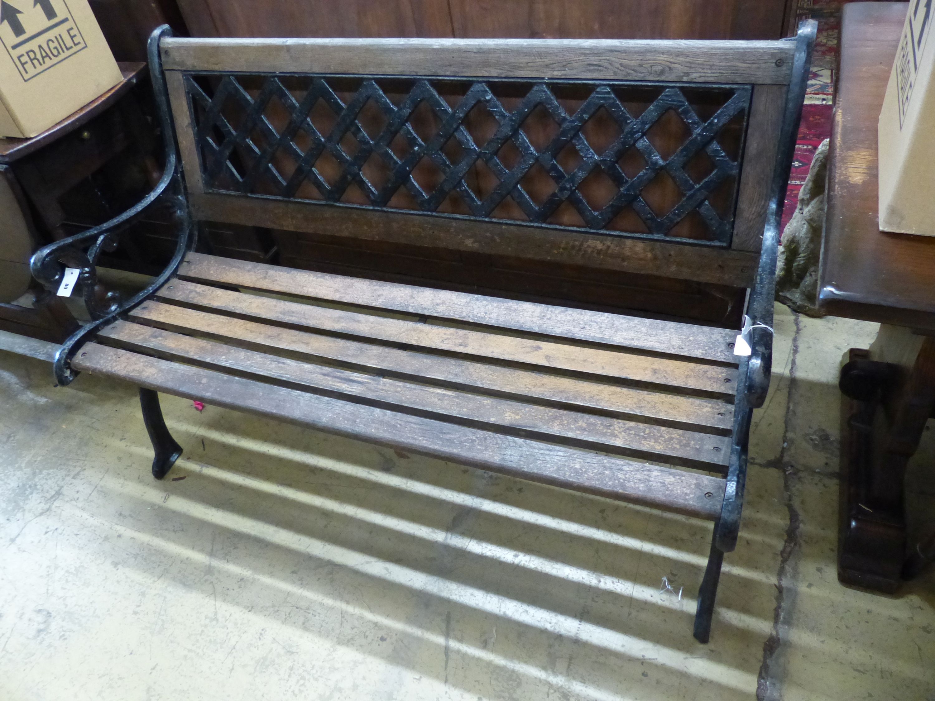 A painted cast metal slatted garden bench, length 127cm, depth 65cm, height 83cm